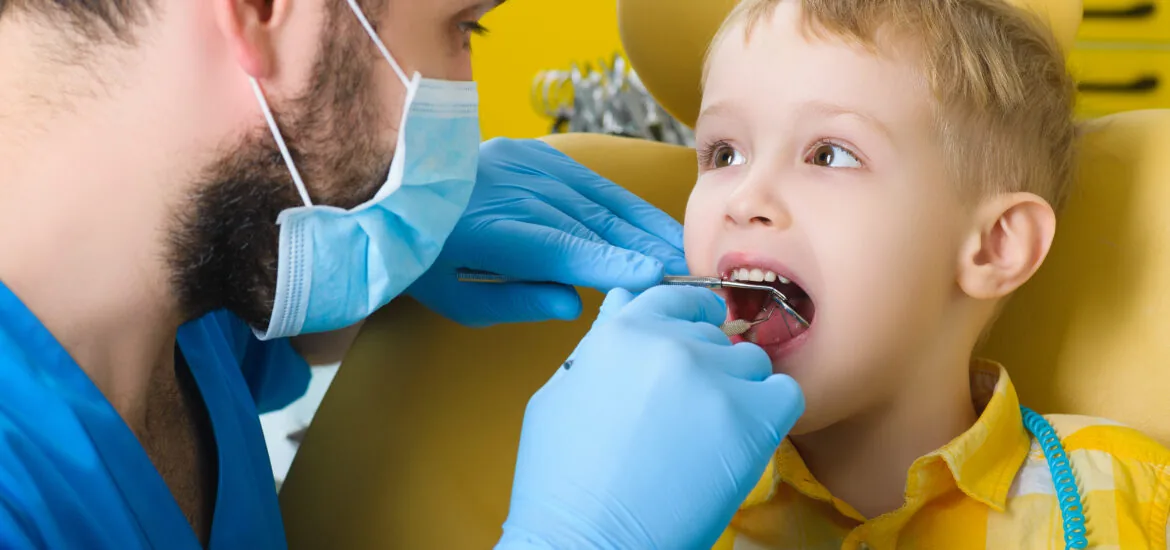 young patient being treated by a dentist in Alexandria
