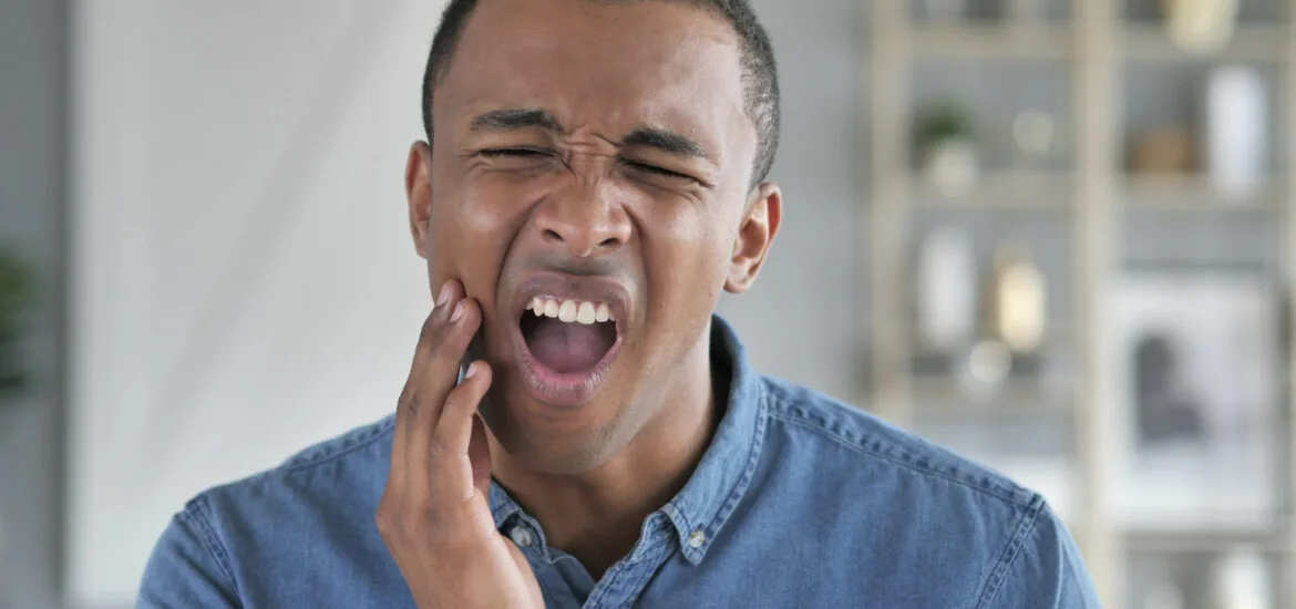 young man suffering from jaw pain, bruxism